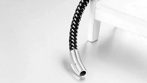 Macro shot of industrial black and silver woven chain with cylindrical metal clasp