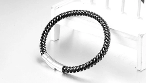 Detail of woven black leather and silver steel thread bracelet with stainless buckle