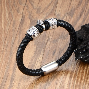 Men's punk leather woven bracelet with silver skull charm and magnetic metal clasp