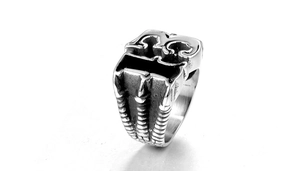 Close-up of vintage stainless steel ring featuring a bold number 13 relief on top