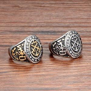 Retro United States Navy men's steel ring with double anchor emblem on wood background
