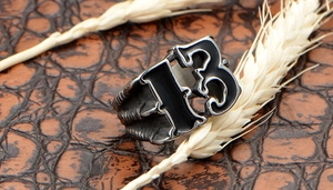 Macro shot of men's vintage number 13 ring with eagle claw texture on leather background