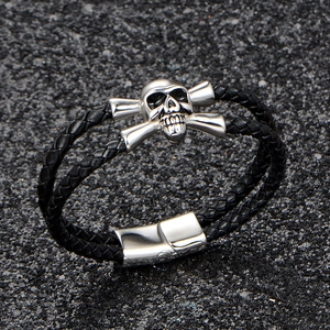 Handcrafted men's black braided leather skull bracelet with stainless steel magnetic clasp