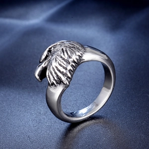 Vintage eagle stainless steel ring with detailed feathers in punk style on blue satin