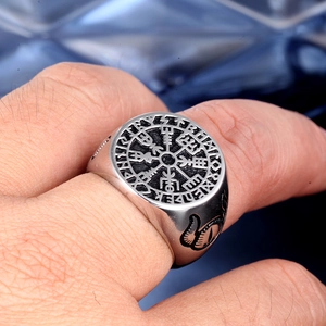 Macro shot of Viking Vegvisir compass ring with rune engravings on stainless steel surface