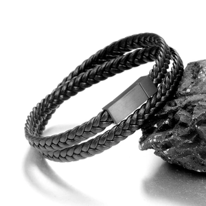 Detail of black double-layered braided leather bracelet with matte metal magnetic clasp