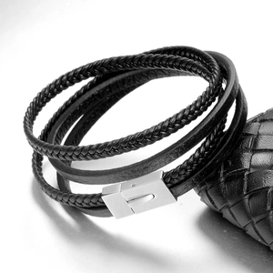 Detail of multi-layer black braided leather bracelet with silver magnetic steel clasp