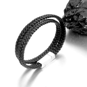Close-up of men's double-braided leather bracelet with magnetic steel clasp on stone