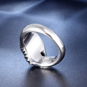 Gothic skull ring in polished stainless steel featuring side relief texture on dark background