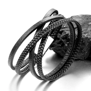 Minimalist multi-layer black woven leather bracelet on stone with mirror reflection