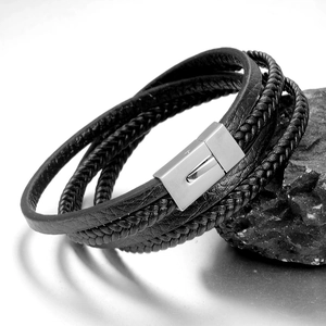 Detail of multi-layer black braided leather bracelet with silver magnetic metal clasp