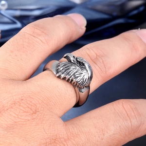 Detailed close-up of a vintage eagle head ring made of rugged stainless steel