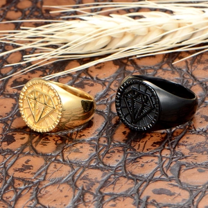 Macro detail of men's crown rings in gold and black finishes with geometric motifs