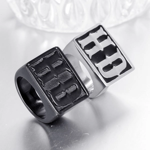 Detail of square signet rings in matte black and silver steel with Gothic HB engraving