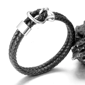 Detail of a black braided leather bracelet with a silver stainless steel D-ring buckle