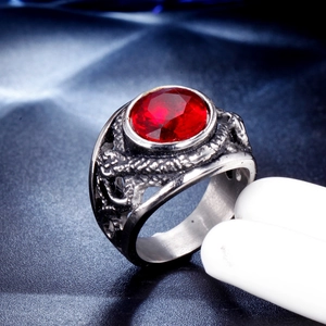 Gothic titanium steel ring featuring a large faceted red gemstone and carved dragon scales