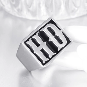 Macro shot of punk style signet ring with gothic HD initials and polished steel finish