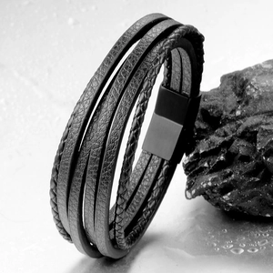 Close-up of multi-layer black leather bracelet for men featuring matte metal magnetic clasp