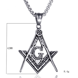 Macro detail of Freemason pendant with compass and G logo in silver stainless steel