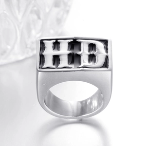 Macro shot of silver titanium steel signet ring with black gothic HD letter design