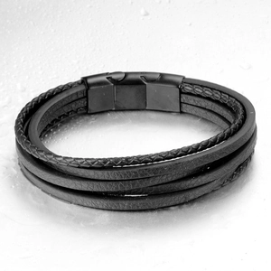 Close-up of multilayer black woven rope and leather bracelet with matte magnetic clasp