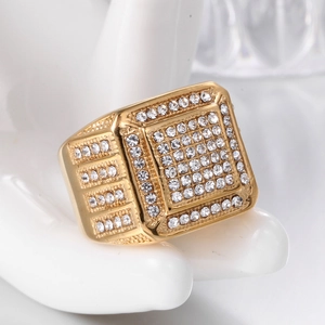 Macro view of gold-plated hip hop square ring featuring micro-paved sparkling crystals