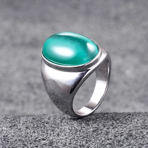 Close-up of men's titanium steel ring featuring a large green cat's eye gemstone