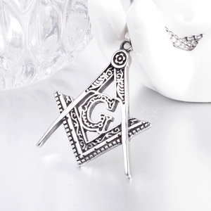Detail of silver Masonic pendant with Square and Compasses and vintage G engraving