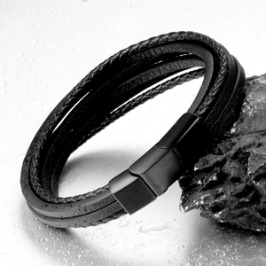 Men's multilayer black braided leather bracelet with matte magnetic steel clasp on rock