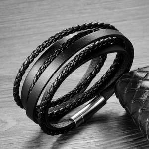 Detail of multi-layer black braided leather bracelet for men with silver magnetic buckle