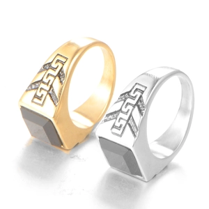 Detail view of gold and silver signet rings featuring square black gemstones and carvings