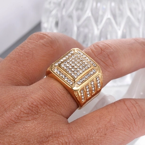 Macro shot of hip hop square gold ring for men with pave set white rhinestones