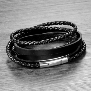 Detail view of multi-layer black braided leather bracelet with silver magnetic steel clasp