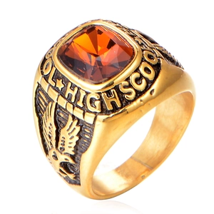 Detail of high school graduation ring with amber gemstone and eagle relief