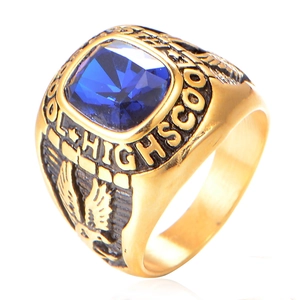 Macro shot of gold class ring with blue gemstone and high school eagle engraving
