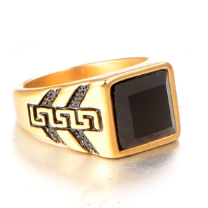Men's square gold ring with black gemstone and Greek key patterns on the sides