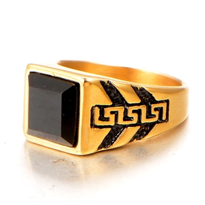 Detailed view of square black stone signet ring with gold Greek meander patterns
