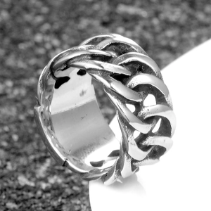 Macro shot of vintage silver curb chain ring with punk style black oxidized finish