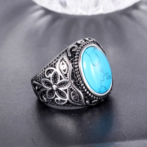 Vintage stainless steel ring for men featuring an oval turquoise stone and floral engraving