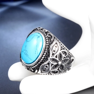 Vintage stainless steel ring with oval blue turquoise and floral relief details