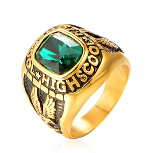Vintage gold men's eagle class ring featuring a large emerald green gemstone and carving