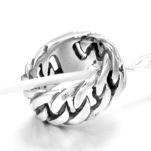 Macro shot of silver cuban link chain ring featuring punk style and thick metal texture