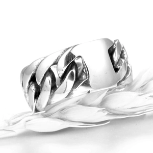 Detailed close-up of a silver cuban chain link ring with a high-polished mirror finish