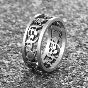 Detail of vintage titanium steel ring with engraved Buddhist mantra symbols and hollow design