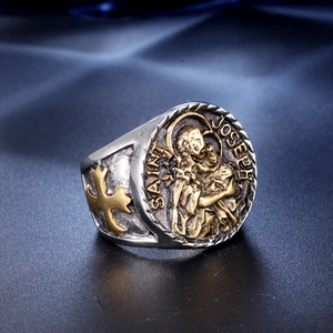 Macro detail of vintage Saint Joseph religious ring in silver and gold steel finish