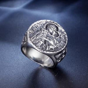 Close-up of Saint Joseph relief on a vintage steel ring with textured band detail