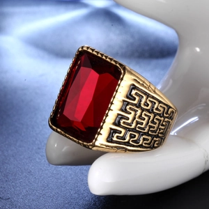 Detail of vintage gold ring with large red rectangular gemstone and Greek Key side patterns