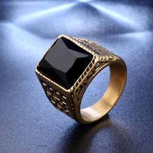 Macro shot of vintage gold stainless steel ring featuring a square black gemstone