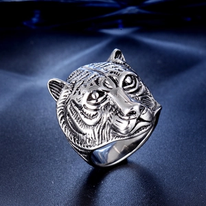 Detailed close-up of retro stainless steel tiger head ring with vintage finish and textures