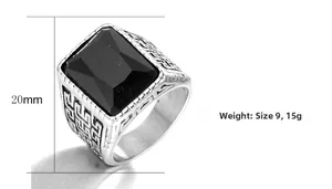 Detail of vintage signet ring featuring a large black gemstone and Greek key patterns